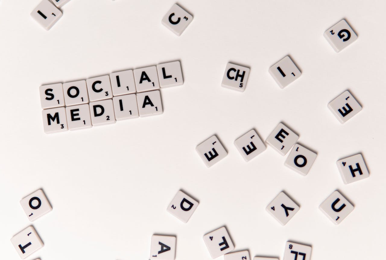Scrabble tiles spelling Social Media on a white background, symbolizing digital communication.